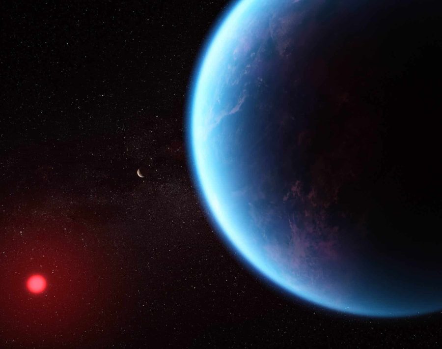 This artist’s concept shows what exoplanet K2-18 b could look like based on science data. K2-18 b, an exoplanet 8.6 times as massive as Earth, orbits the cool dwarf star K2-18 in the habitable zone and lies 120 light-years from Earth. A new investigation with the NASA/ESA/CSA James Webb Space Telescope into K2-18 b has revealed the presence of carbon-bearing molecules including methane and carbon dioxide. The abundance of methane and carbon dioxide, and shortage of ammonia, support the hypothesis that there may be an ocean underneath a hydrogen-rich atmosphere in K2-18 b. [Image description: Illustration of an exoplanet planet and its red cool dwarf star on a black background that is speckled with some small stars. The planet is large, in the foreground on the right and the star is smaller, in the background at the lower left. The planet is various shades of blue, with wisps of white scattered throughout. The left edge of the planet (the side facing the star) is lit, while the rest is in shadow. The star has a bright red glow.]